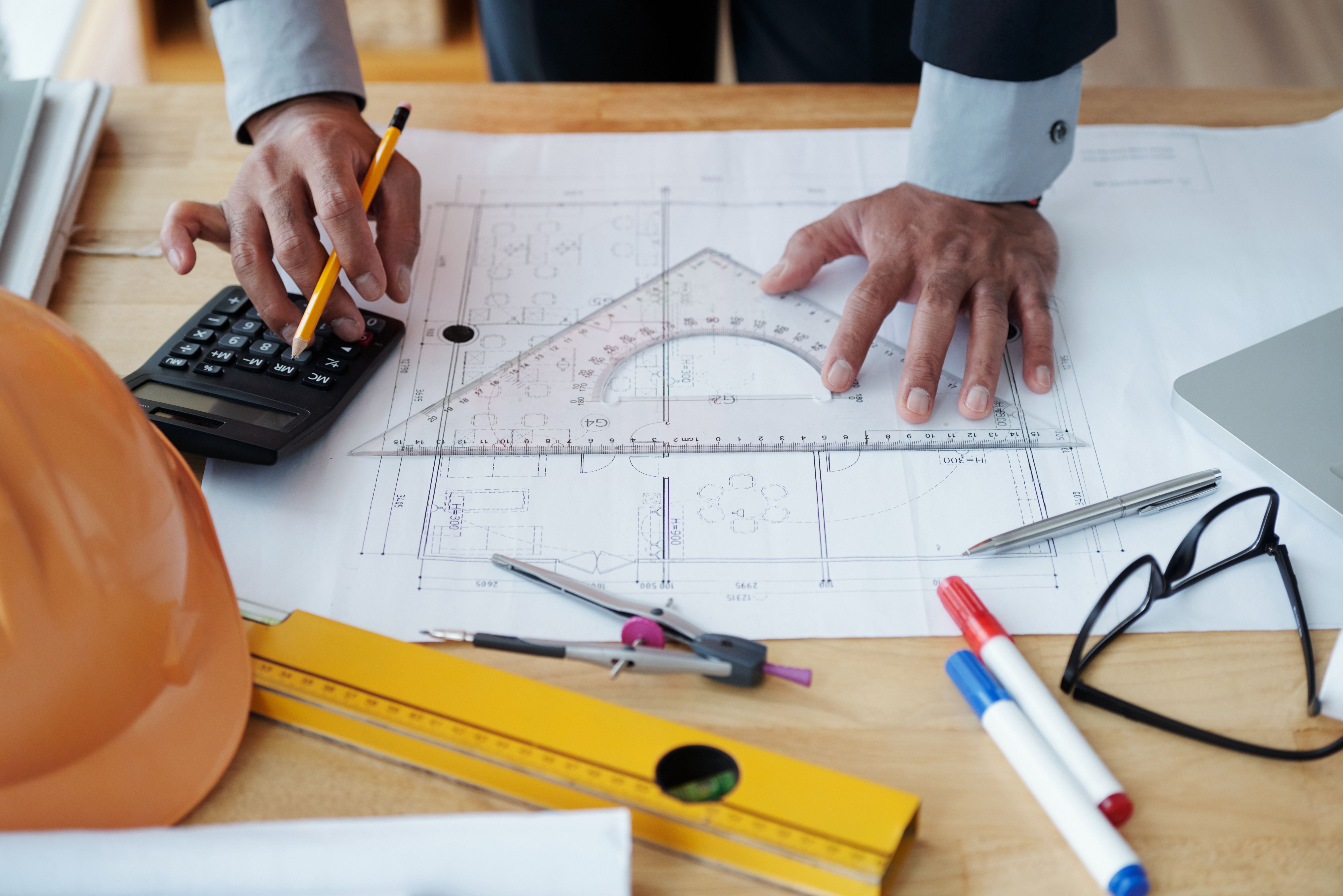 hands-unrecognizable-male-architect-working-technical-drawing-using-calculator.jpg